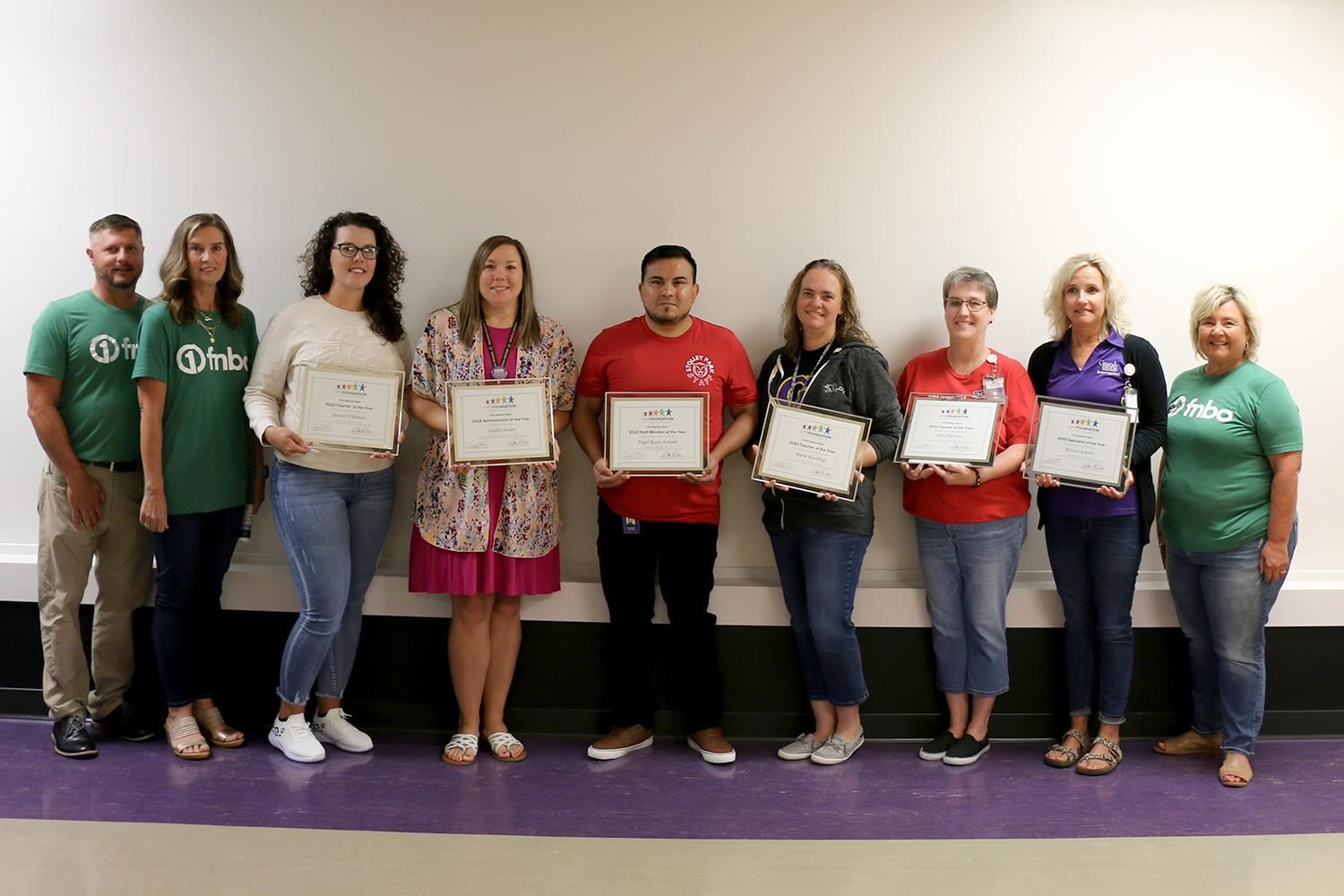 GIPS Teacher of the Year award winners standing with their awards alongside First National Bank presenting sponsors